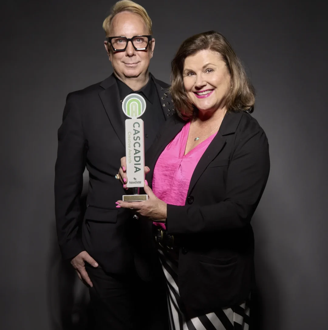 Beth Erlendson and Jim Parker receiving the design excellence award from Cascadia